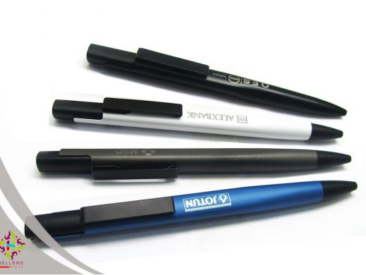 Four branded promotional ballpoint pens: black, white, gray, and blue.