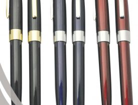 Six HELLEN'S Group glossy rollerball pens in black, grey, and maroon with gold/silver accents.