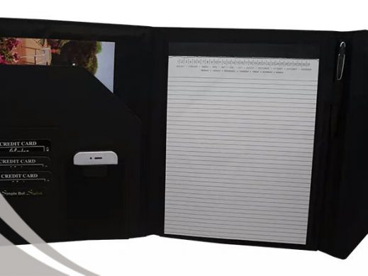 Black leather portfolio organizer with notepad, card slots, and pen.