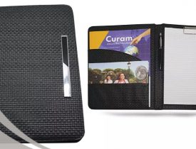 Black HELLEN'S Group textured portfolio with pen, notepad, and promotional materials.