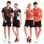 Dynamic athletic models showcasing orange and black tiger-stripe badminton sports uniforms.