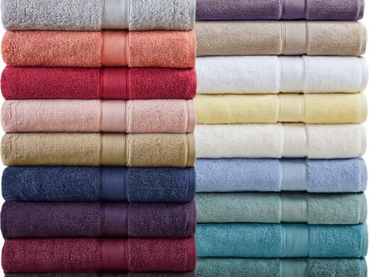 Abundant, neatly folded bath towels displayed in various colors and textures.