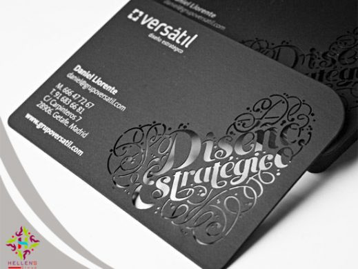 Premium black business card with intricate die-cut scrollwork and white text.