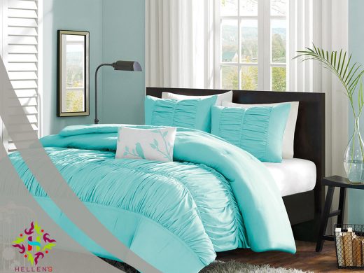 Turquoise ruched linen bedding in a modern bedroom with seafoam walls.