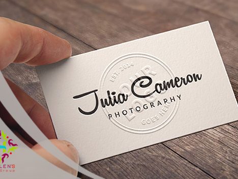 Textured white business card for Julia Cameron Photography on wood.