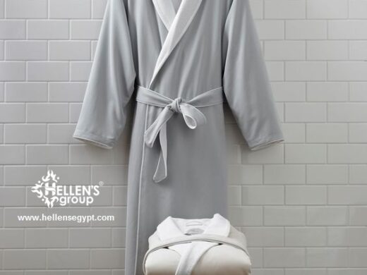 Luxurious Hellen's Group bathrobes and towels displayed against white subway tiles.