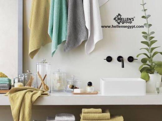 Spa-like bathroom with textured, muted color towels, black faucet, and wicker storage.