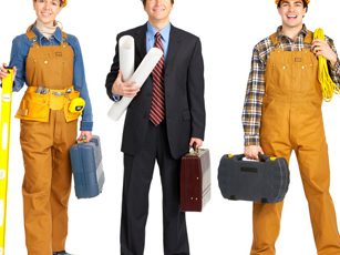 Team of construction professionals in hard hats and factory uniforms with tools.