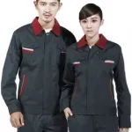 Professional models wearing matching dark gray industrial work uniforms with red collars.